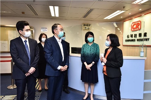 The Secretary for Financial Services and the Treasury, Mr Christopher Hui, visited the Companies Registry today (May 8). Photo shows Mr Hui (second left), accompanied by the Registrar of Companies, Ms Ada Chung (second right), being briefed on its operation after full resumption of public services.