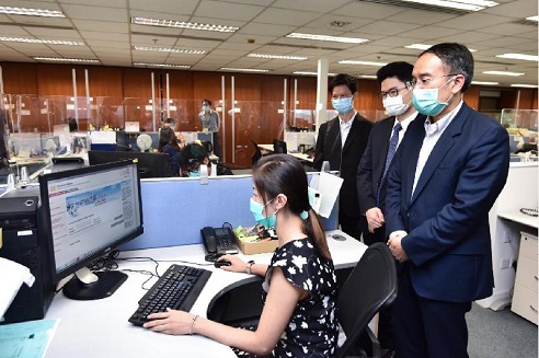 The Secretary for Financial Services and the Treasury, Mr Christopher Hui, visited the Companies Registry today (May 8). Photo shows Mr Hui (first right) inspecting the work of the department.