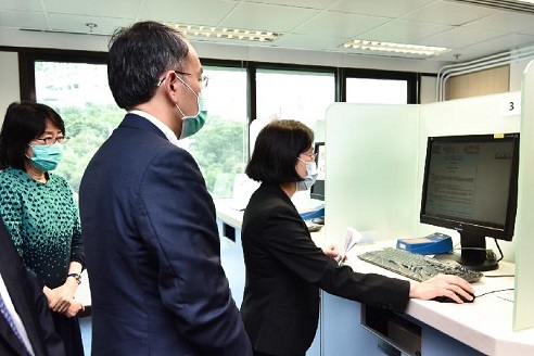 The Secretary for Financial Services and the Treasury, Mr Christopher Hui, visited the Companies Registry today (May 8). Photo shows Mr Hui (eighth right), accompanied by the Registrar of Companies, Ms Ada Chung (ninth right), chatting with staff there to better understand their work conditions and the services that they provide.