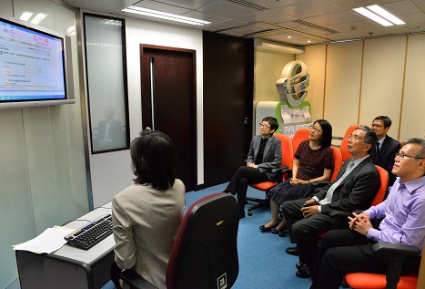 Mr James LAU, JP, the Secretary for Financial Services and the Treasury (right two), viewing the demonstration of conducting searches on company information at the Cyber Search Centre