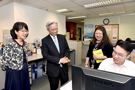 Mr Joshua LAW, the Secretary for the Civil Service (left two) observing the work of staff of Document Management Section 